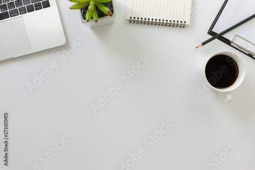 Flay lay, Top view office table desk with computer laptop, coffee, pencil, leaves with copy space white background.