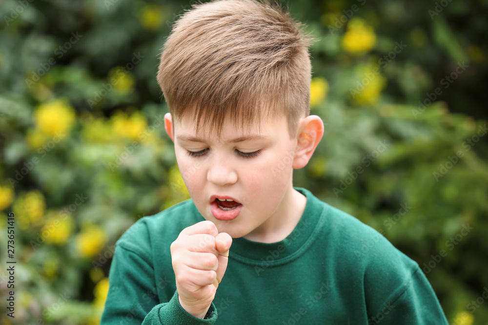 Boy having asthma attack outdoors on spring day Boy having asthma attack outdoors on spring day