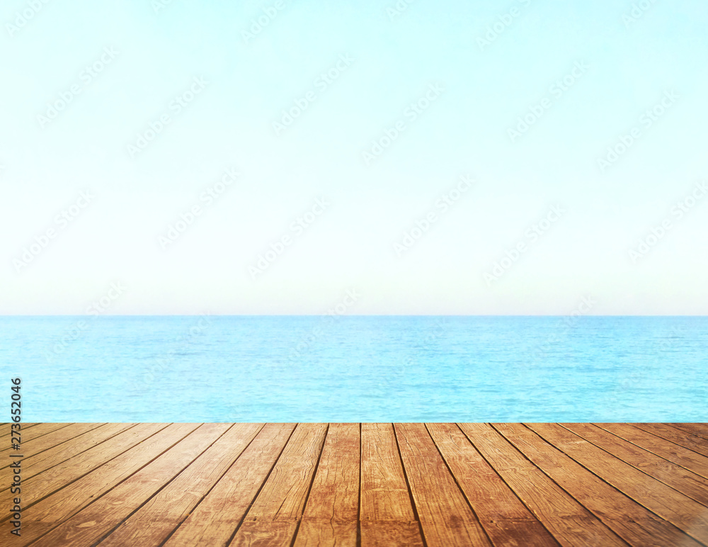 Table top with beach background, sky and cloud in sunny day for product display job showing. Wooden table for display or montage your products.