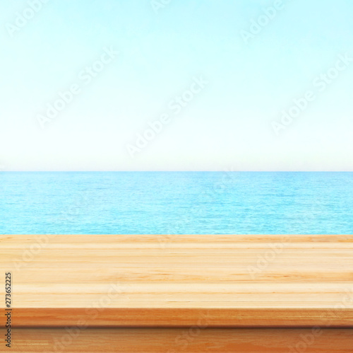 Table top with beach background  sky and cloud in sunny day for product display job showing. Wooden table for display or montage your products.