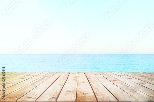 Table top with sea background  sky and cloud in sunny day for product display job showing. Wooden table for display or montage your products.