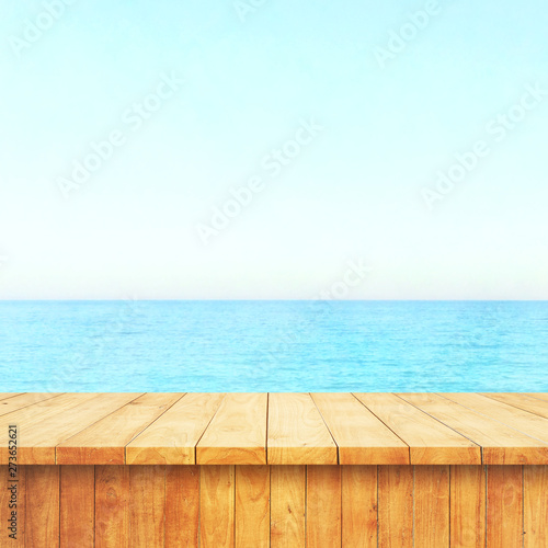 Table top with beach background  sky and cloud in sunny day for product display job showing. Wooden table for display or montage your products.