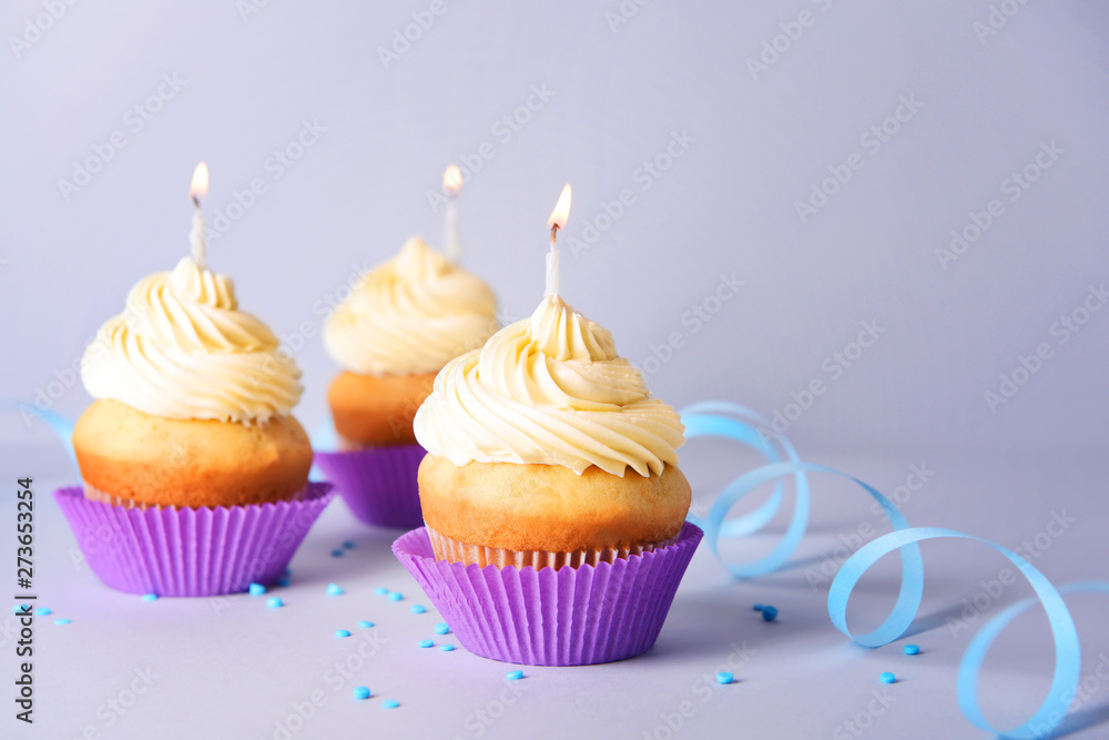 Tasty Birthday cupcakes on grey background Tasty Birthday cupcakes on grey background