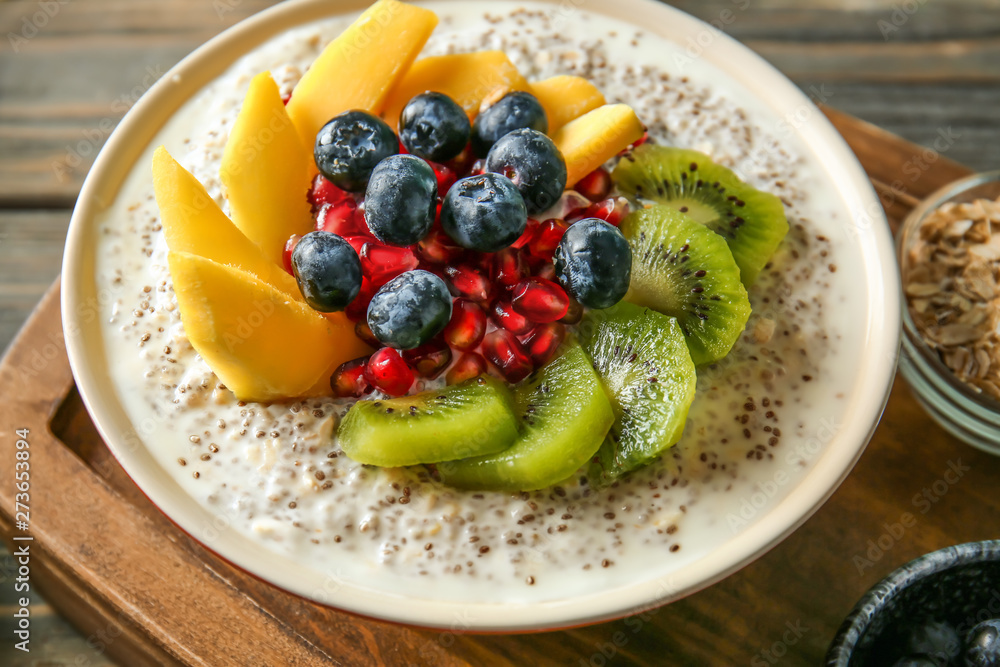 Bowl with tasty chia dessert on wooden board Bowl with tasty chia dessert on wooden board