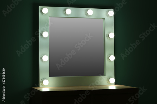 Table with mirror in modern makeup room © Pixel-Shot