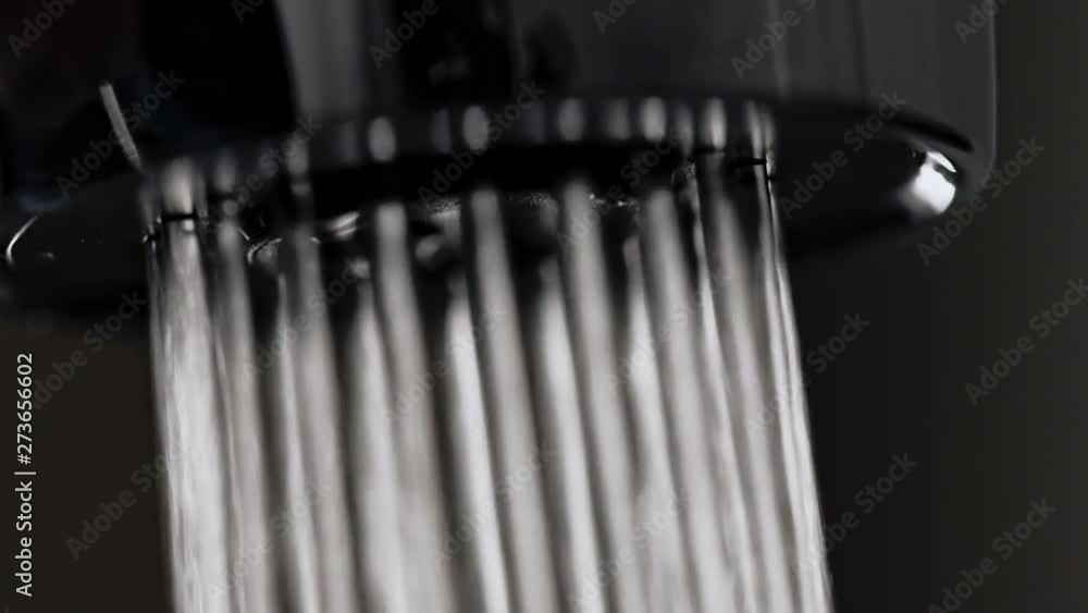 Low angle closeup stream of clear water starting and stopping to flow from faucet of modern shower in bathroom - slow motion. Low angle closeup stream of clear water starting and stopping to flow from faucet of modern shower in bathroom - slow motion.
