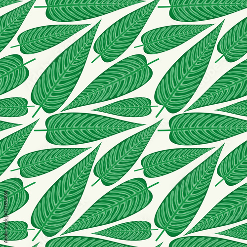 Seamless pattern with tropical leaves on a green background.