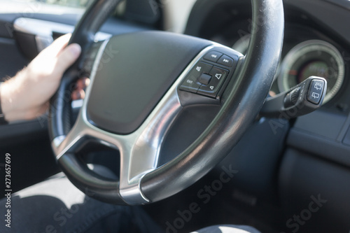 Man driving car, the left hand holding steering wheel © Андрей Репетий