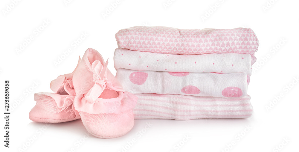 Stack of baby clothes and shoes on white background Stack of baby clothes and shoes on white background