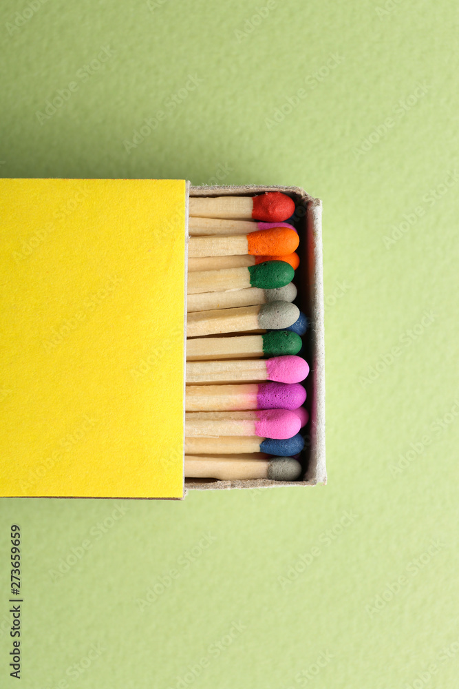 Box with matches on color background Box with matches on color background