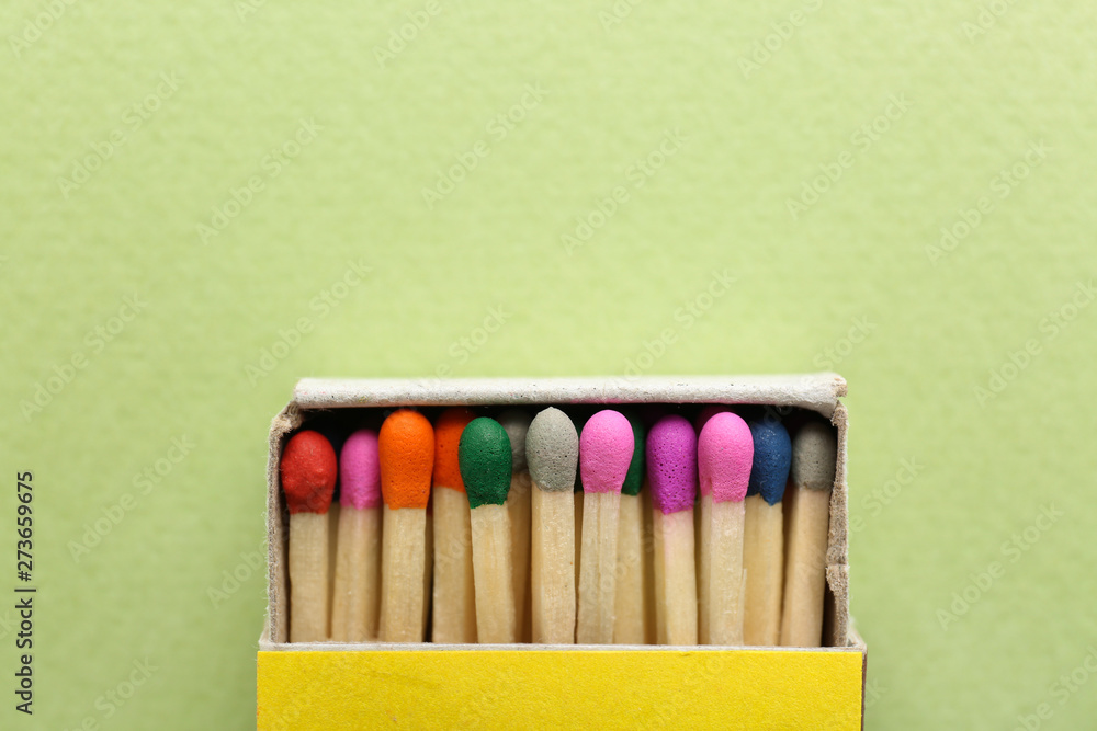 Box with matches on color background Box with matches on color background