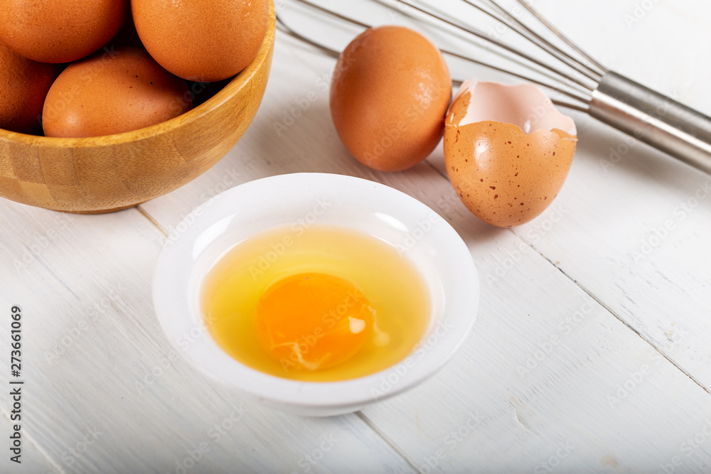 Fresh egg yolks in a porcelain bowl Fresh egg yolks in a porcelain bowl