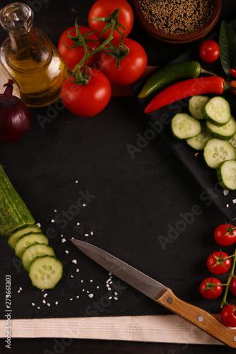 Healthy food. Vegetables on a black plate and stone cutting board and wooden background. Top View and copy space.