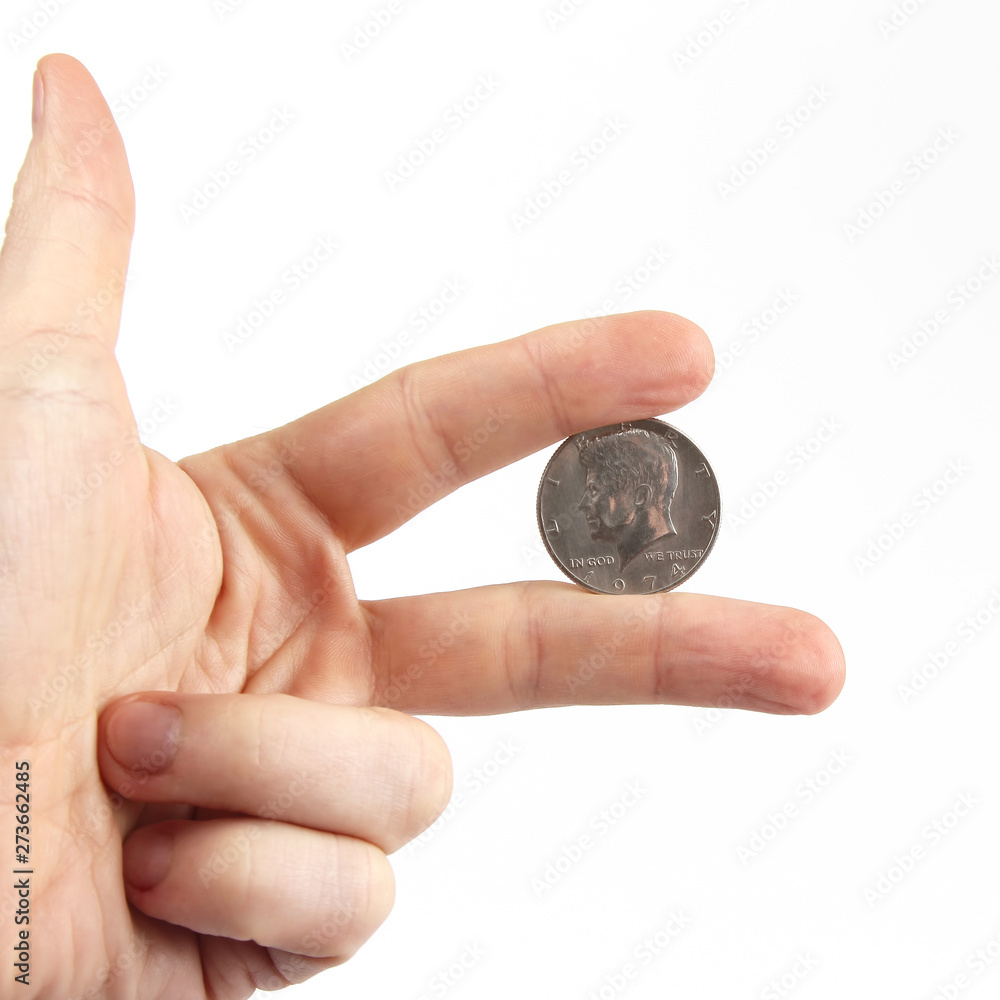 fingers of the hand holding the coin. Finance and Economics. fingers of the hand holding the coin. Finance and Economics.