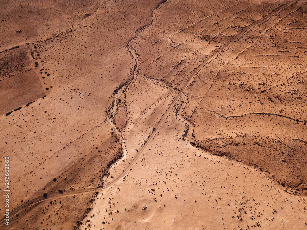 Aerial view of a desert landscape on the island of Lanzarote, Canary Islands, Spain. Desert background, texture. Sand and desolate land Aerial view of a desert landscape on the island of Lanzarote, Canary Islands, Spain. Desert background, texture. Sand and desolate land