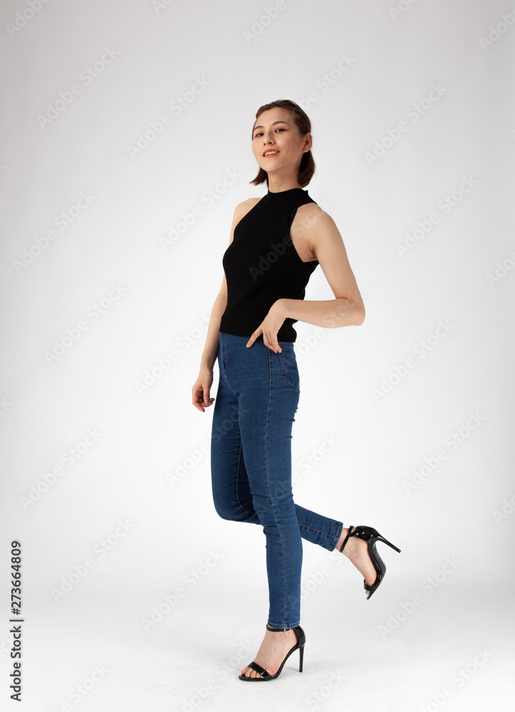 Asian Chinese Fashion influencer modeling in black top and tight jeans  isolated in white background Stock Photo | Adobe Stock