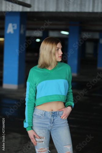 The girl is blonde in a green blue croptop. Street style. Advertising brand clothing. Fashion Shooting © Yaroslav
