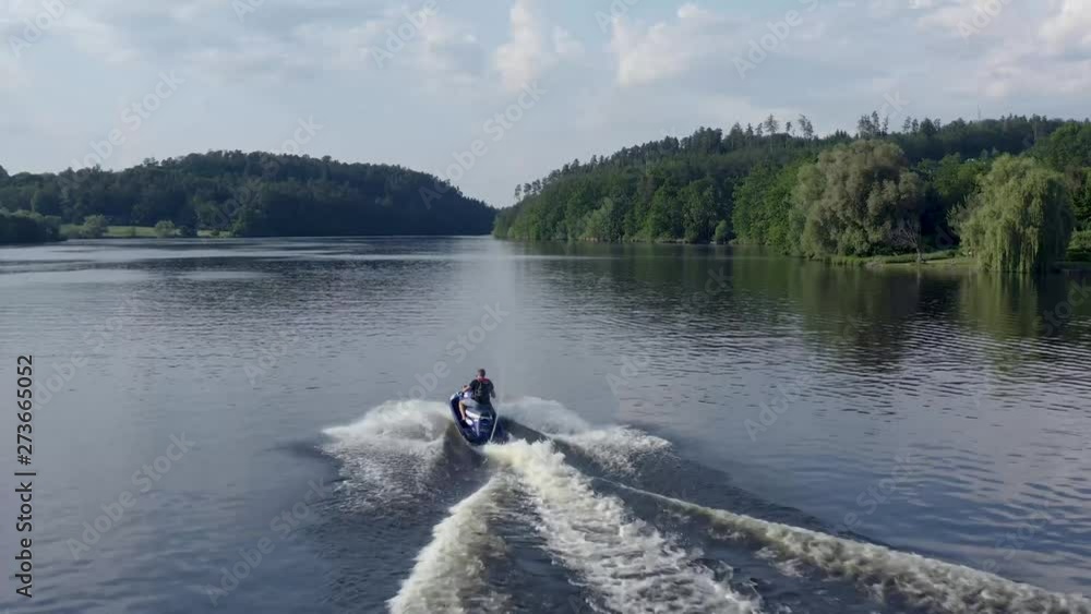 Jet ski riding on water surface of the lake - water scooter Jet ski riding on water surface of the lake - water scooter