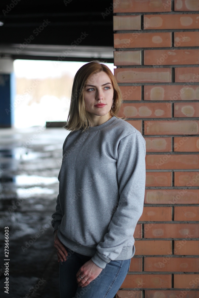 Girl blonde in grey hoodie. Street style. Advertising brand clothing. Fashion Shooting. Mockup. Girl blonde in grey hoodie. Street style. Advertising brand clothing. Fashion Shooting. Mockup.