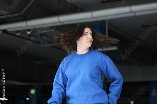 Girl in blue hoodie. Street style. Advertising brand clothing. Fashion Shooting. Mockup.