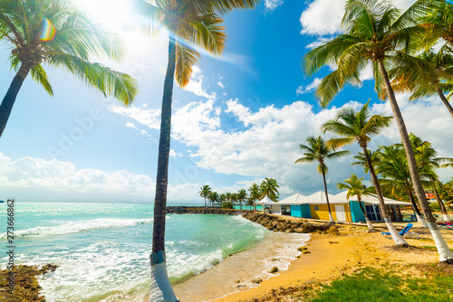Fototapeta Naklejka Na Ścianę i Meble -  Sun shining over beautiful Bas du Fort beach in Guadeloupe