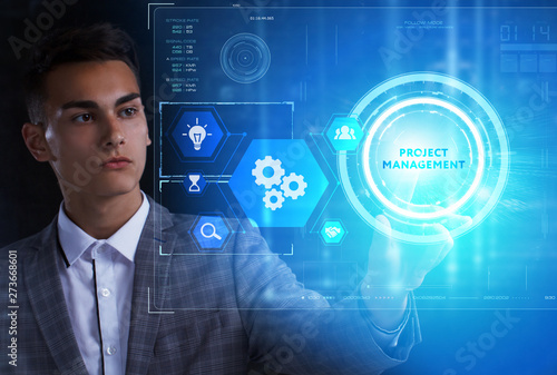 The concept of business, technology, the Internet and the network. A young entrepreneur working on a virtual screen of the future and sees the inscription: Project management