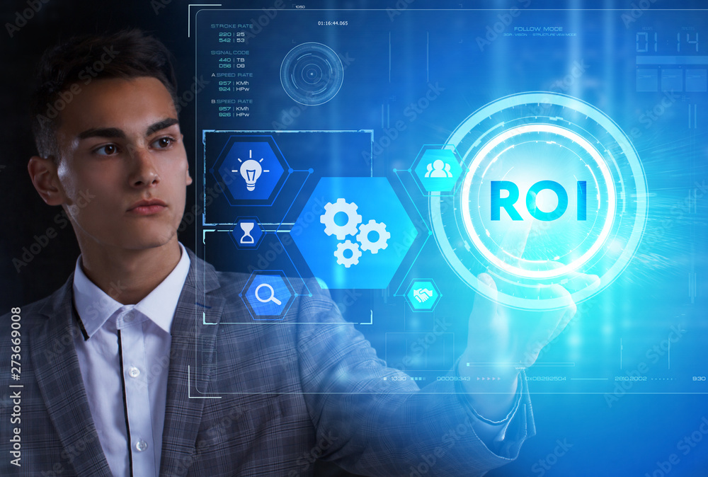 The concept of business, technology, the Internet and the network. A young entrepreneur working on a virtual screen of the future and sees the inscription: ROI The concept of business, technology, the Internet and the network. A young entrepreneur working on a virtual screen of the future and sees the inscription: ROI