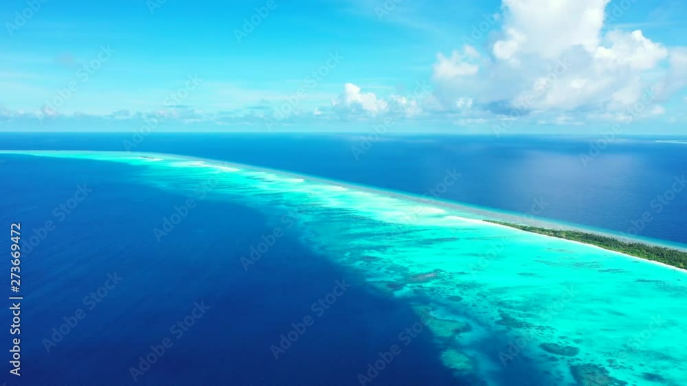 Bird's eye view of the Coral reef in the Maldives islands, Indian Ocean. Dramatic clouds in the background and pure turquoise waters in the foreground Bird's eye view of the Coral reef in the Maldives islands, Indian Ocean. Dramatic clouds in the background and pure turquoise waters in the foreground