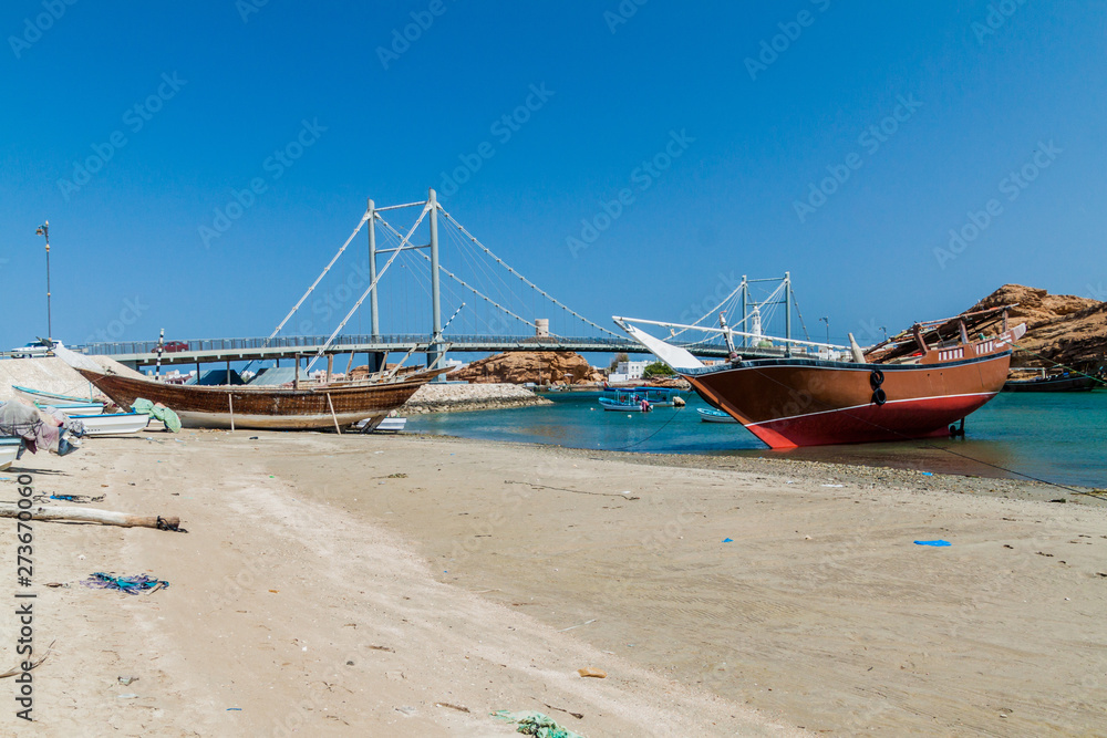 Traditional dhow boat yards in Sur, Oman. Khor al Batar bridge in the background.