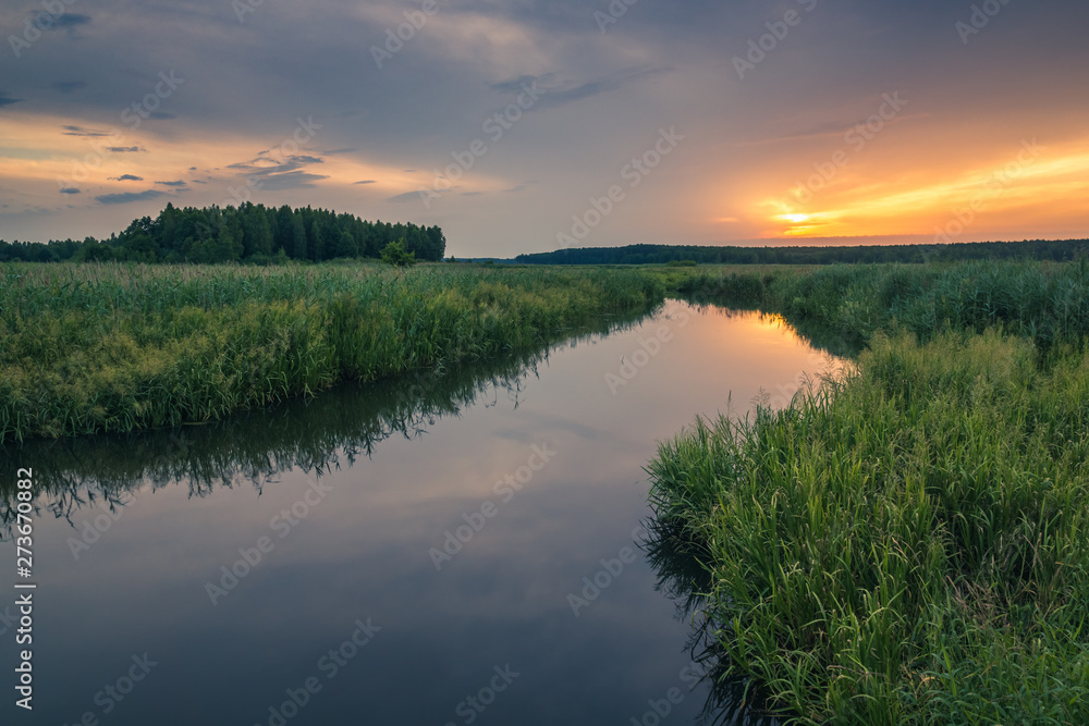 Sunrise over the backwaters Luciaza river near Sulejow, Lodzkie, Poand