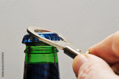 opening a bottle with an opener