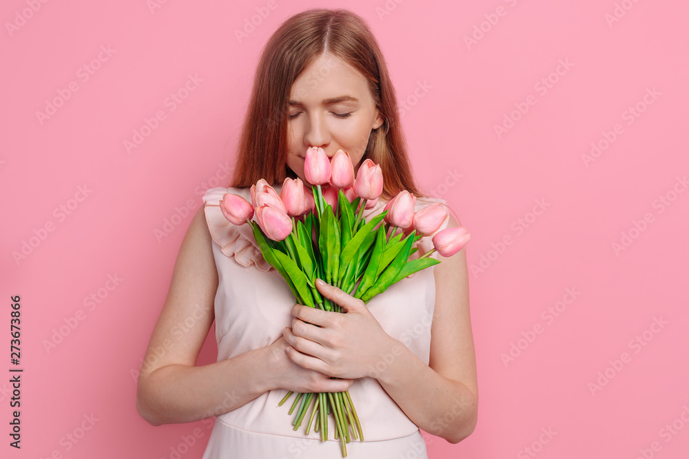 Happy girl in summer dress holding a bouquet of flowers in hand Happy girl in summer dress holding a bouquet of flowers in hand