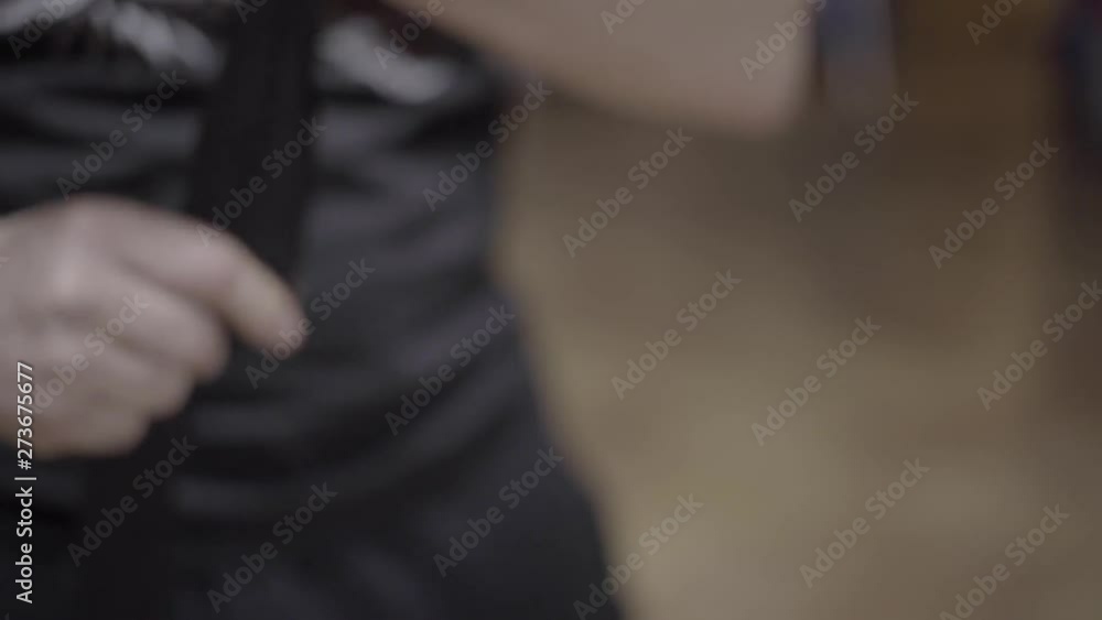 SLOW MOTION: Boxer instructs others how to wrap their hands for boxing. SLOW MOTION: Boxer instructs others how to wrap their hands for boxing.