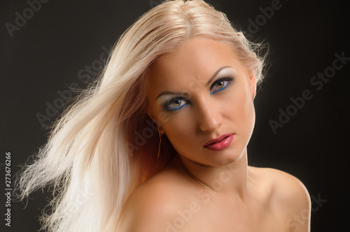 Young stylish woman with long blonde hair and glamour makeup