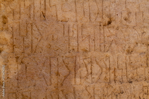 Ancient Kursi inscriptions in Sumhuram Archaeological Park with ruins of ancient town Khor Rori near Salalah, Oman