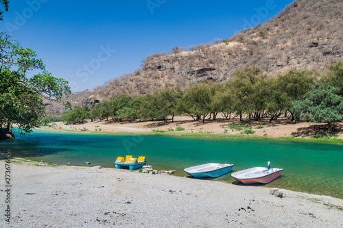 Boats at a small lake at Wadi Dharbat near Salalah, Oman.