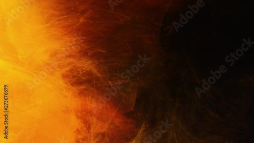 Solar flare and coronal mass ejection effect. Orange inks flowing in dark background. Light motion.