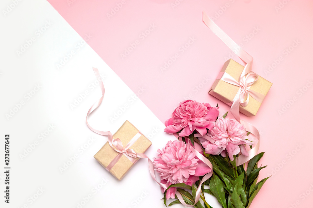 Mothers Day. Festive concept of peonies and gifts on a white and pink background with copy space. You can use it for text for banner, poster, site.