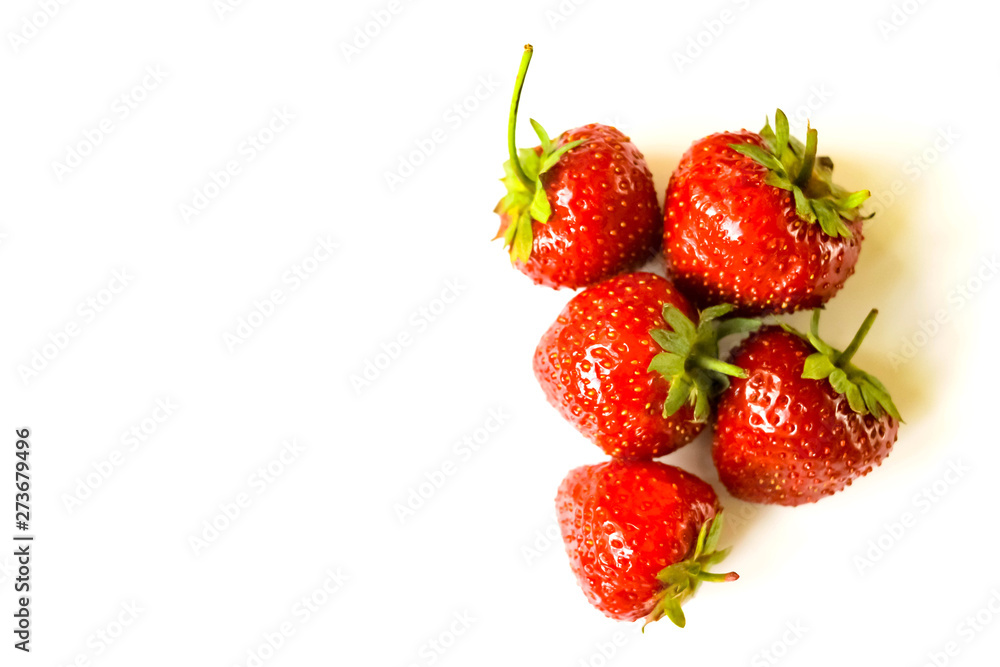 Red strawberries heap on white background view. Selective soft focus. Text copy space. Red strawberries heap on white background view. Selective soft focus. Text copy space.