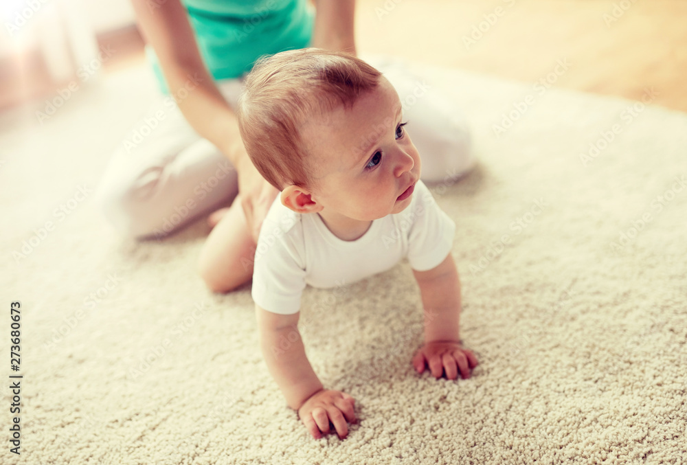 family, child and parenthood concept - mother with little baby on floor at home family, child and parenthood concept - mother with little baby on floor at home