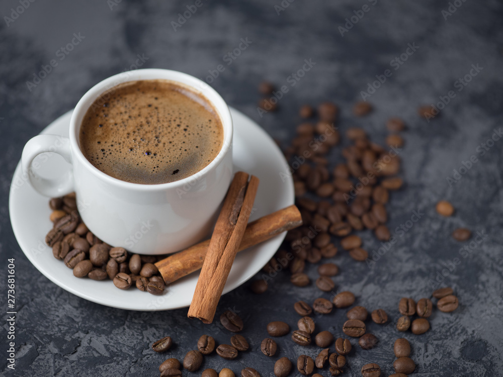 White Cup of espresso coffee with cinnamon on the copyspace concrete table White Cup of espresso coffee with cinnamon on the copyspace concrete table