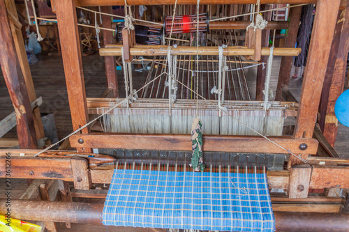 INLE, MYANMAR - NOVEMBER 28, 2016: Loom in Myat Pwint Chel  weaving workshop Inn Paw Khone village at Inle lake, Myanmar photo