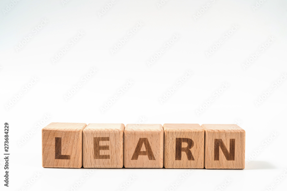 word LEARN on wood cube dices on white background. word LEARN on wood cube dices on white background.