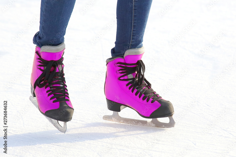 Female legs in skates on an ice rink. sports, Hobbies and recreation of active people. Female legs in skates on an ice rink. sports, Hobbies and recreation of active people.