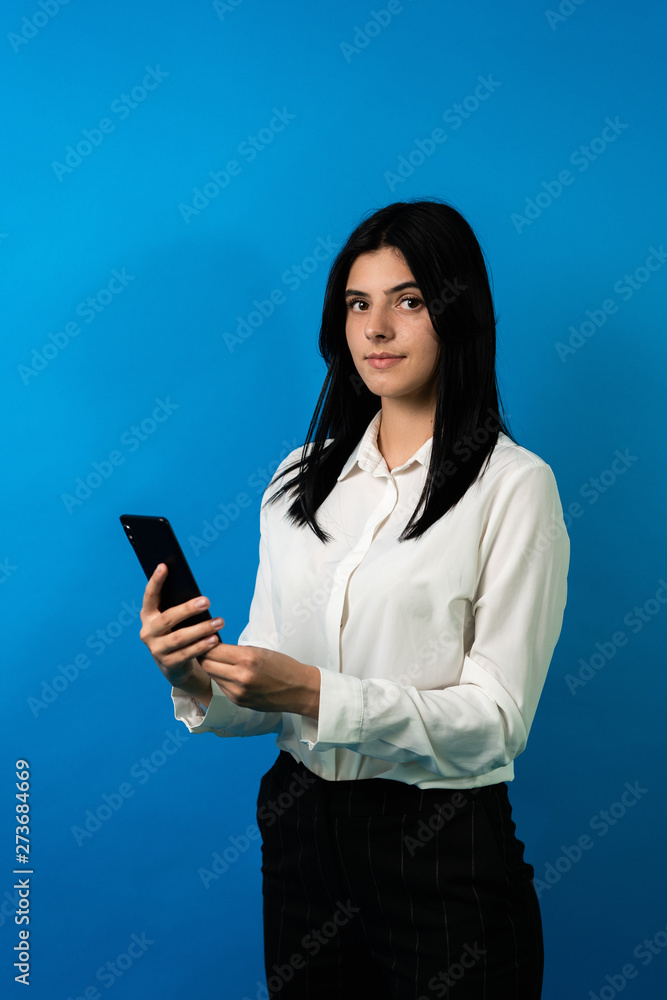 business woman with smartphone, look at camera, smile. Vertical photo business woman with smartphone, look at camera, smile. Vertical photo