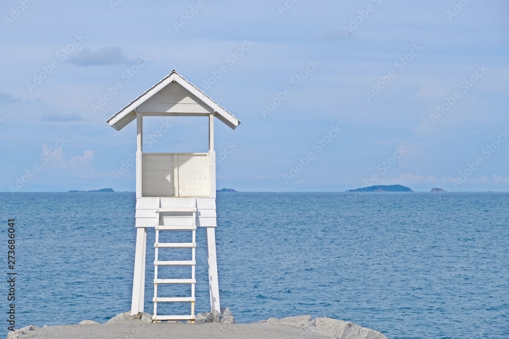 Little wooden white life guard tower at the sea on left of frame, Khao Laem Ya–Mu Ko Samet National Park, Rayong province, Thailand. Little wooden white life guard tower at the sea on left of frame, Khao Laem Ya–Mu Ko Samet National Park, Rayong province, Thailand.
