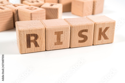 RISK wooden blocks of business concept isolated on white background.