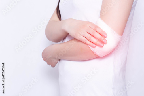 Wallpaper Mural Medical compress on the elbow of the girl for pain and inflammation, white background, copy space, anesthesia Torontodigital.ca