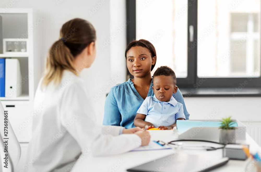 medicine, healthcare and pediatry concept - african american mother with baby son and caucasian doctor at clinic medicine, healthcare and pediatry concept - african american mother with baby son and caucasian doctor at clinic