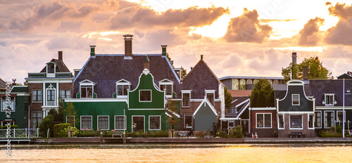 Typically traditional Dutch architecture wooden houses, near water at the Zaanse Schans, Amsterdam photo